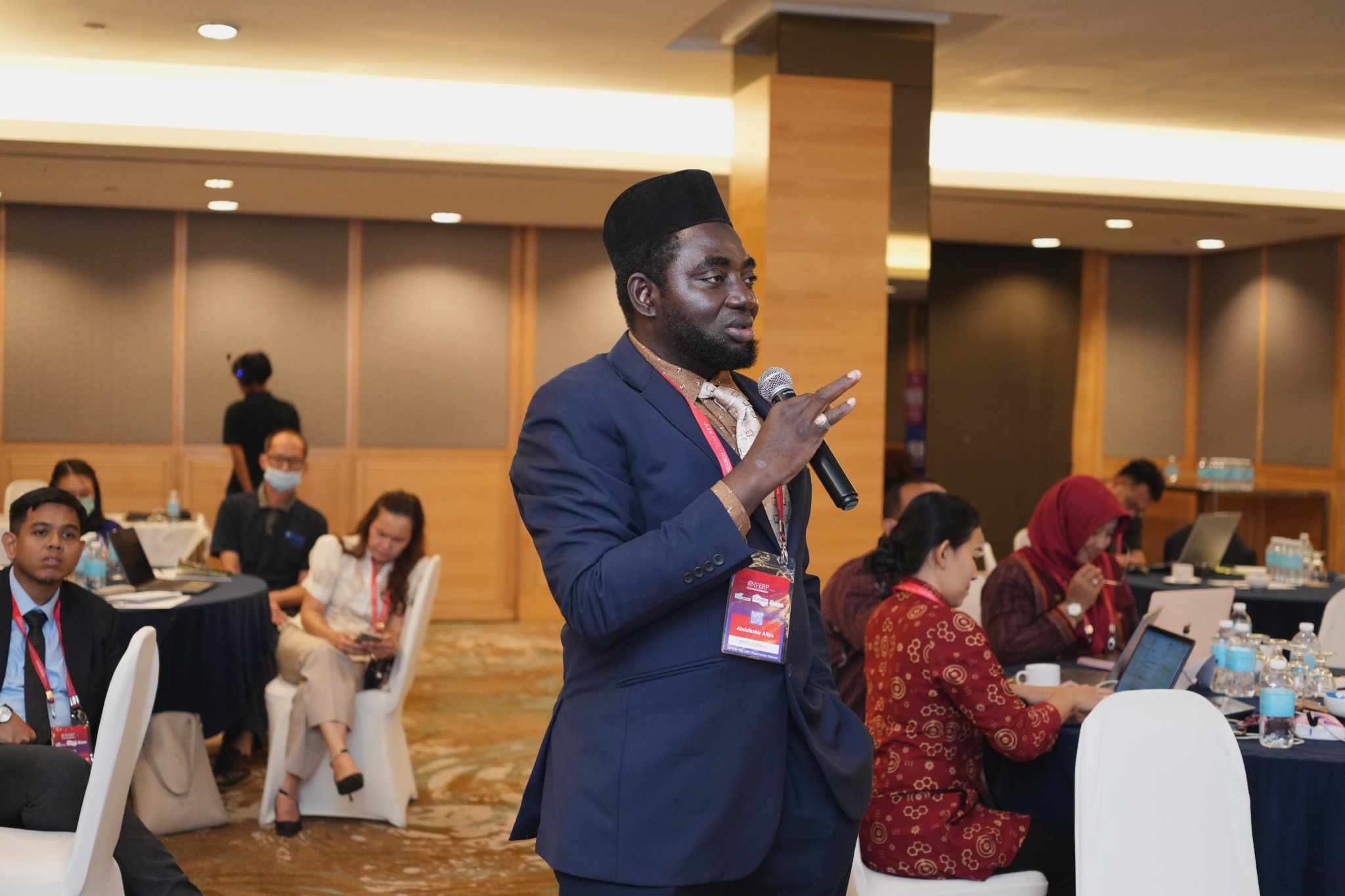 A delegate contributing to discussion at an IFERP conference session